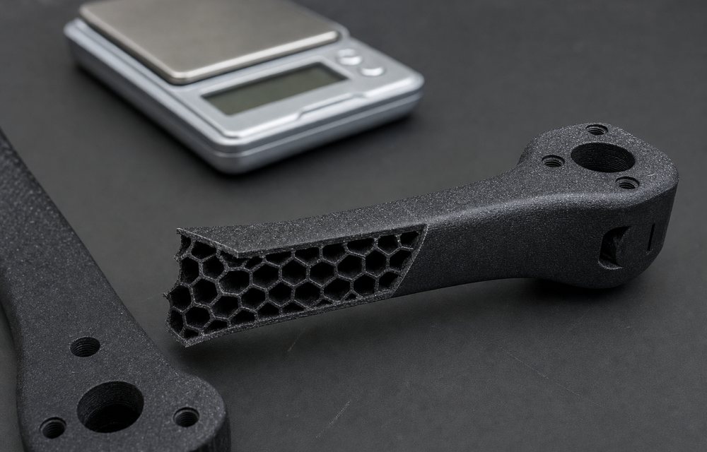 A carbon-fibre nylon drone arm cut open to show its internal lattice