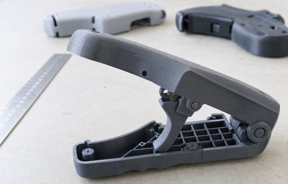A 3D printed functional prototype assembly being flexed and tested