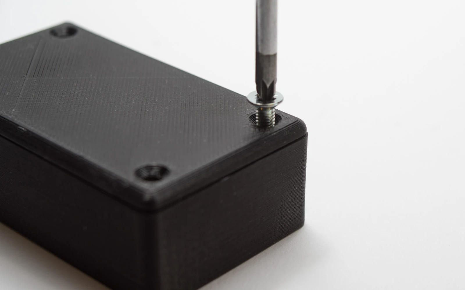 Black carbon-fiber-reinforced nylon 3D printed structural electronics enclosure with internal circuit board