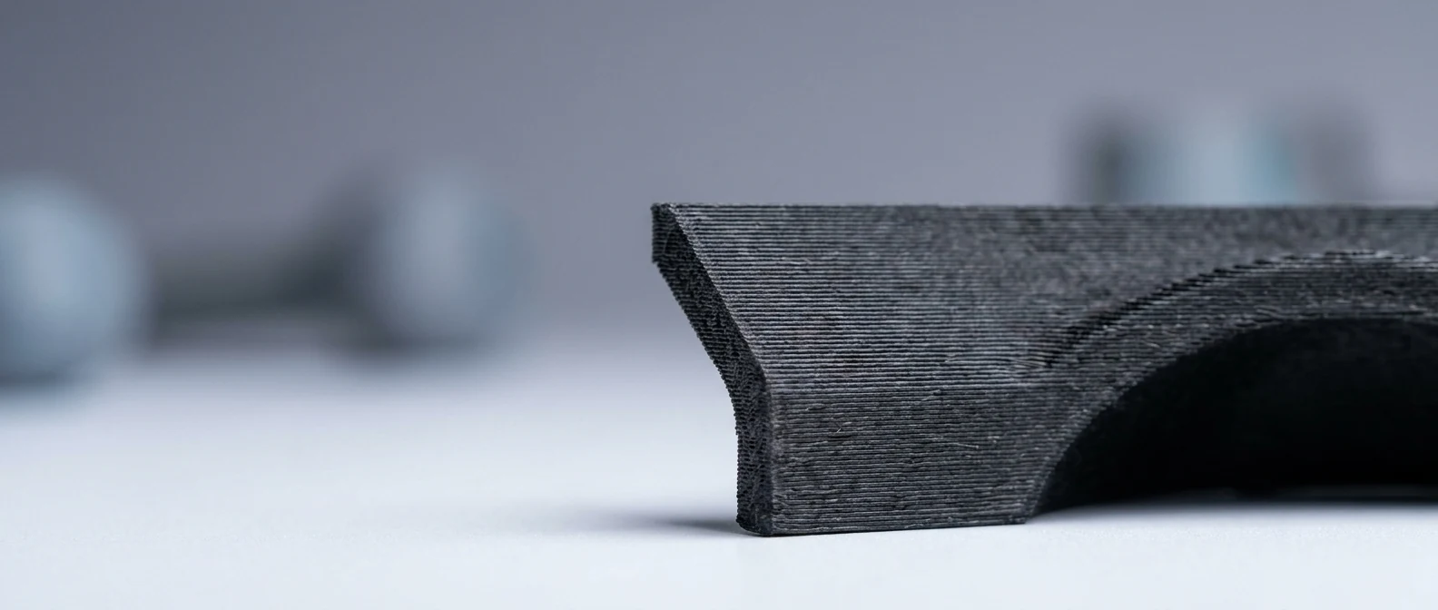 Cross-section of carbon fiber nylon part showing strong layer bonding