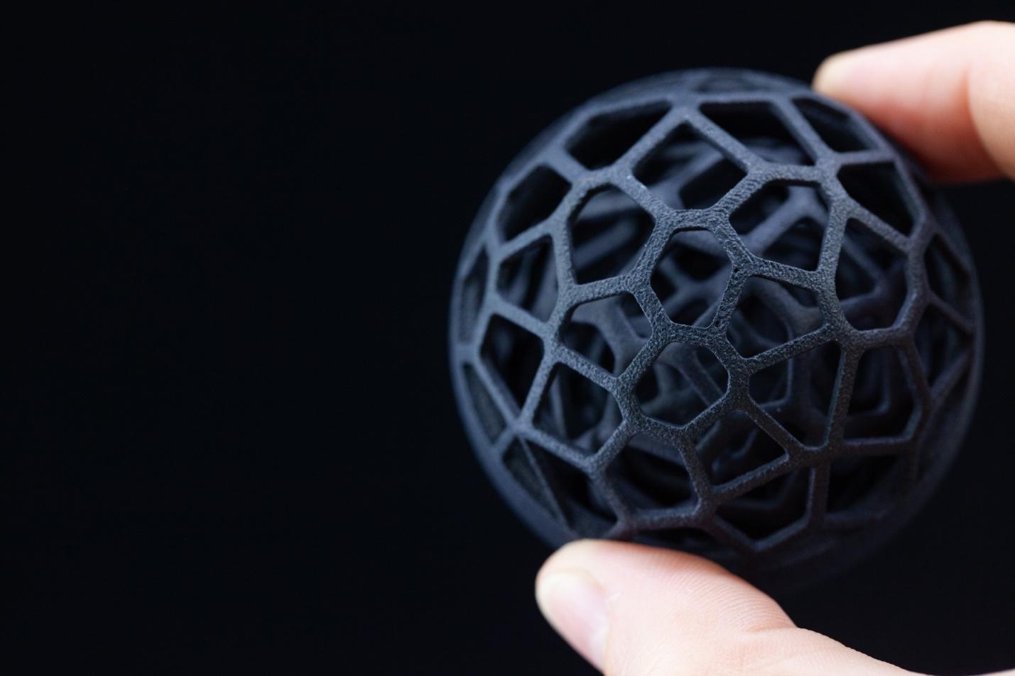 A lattice part printed for a research project, held in the hand