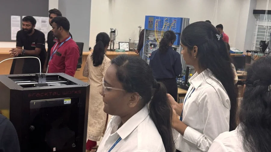 Students around a Fracktal Works 3D printer in a college laboratory