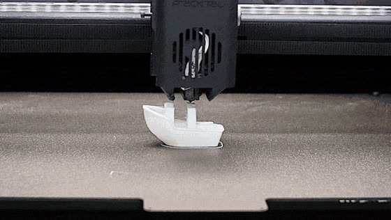 A printed part partly lifted from the build plate with the nozzle still printing above it