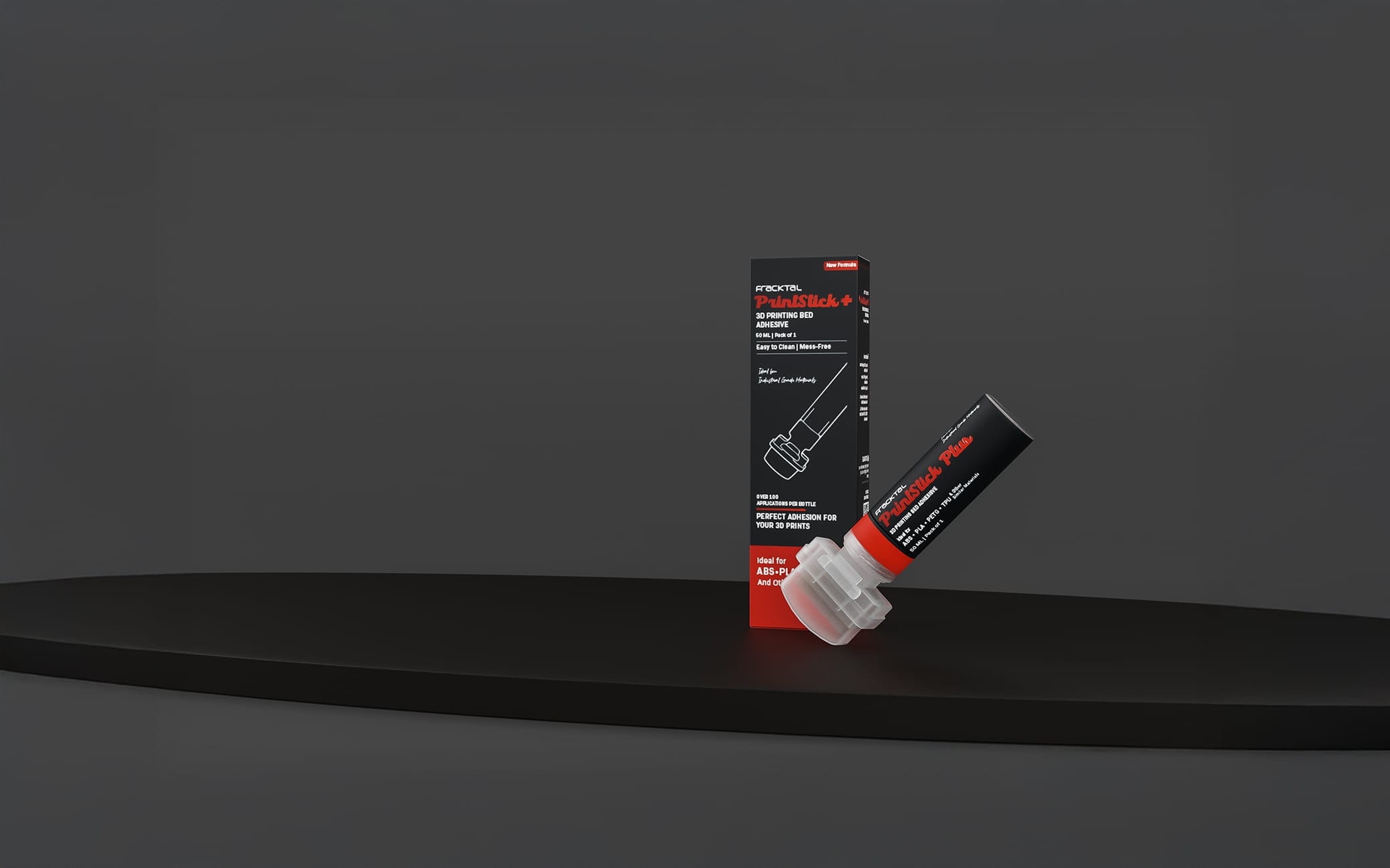 Fracktal PrintStick Plus retail box and applicator bottle on a dark studio podium