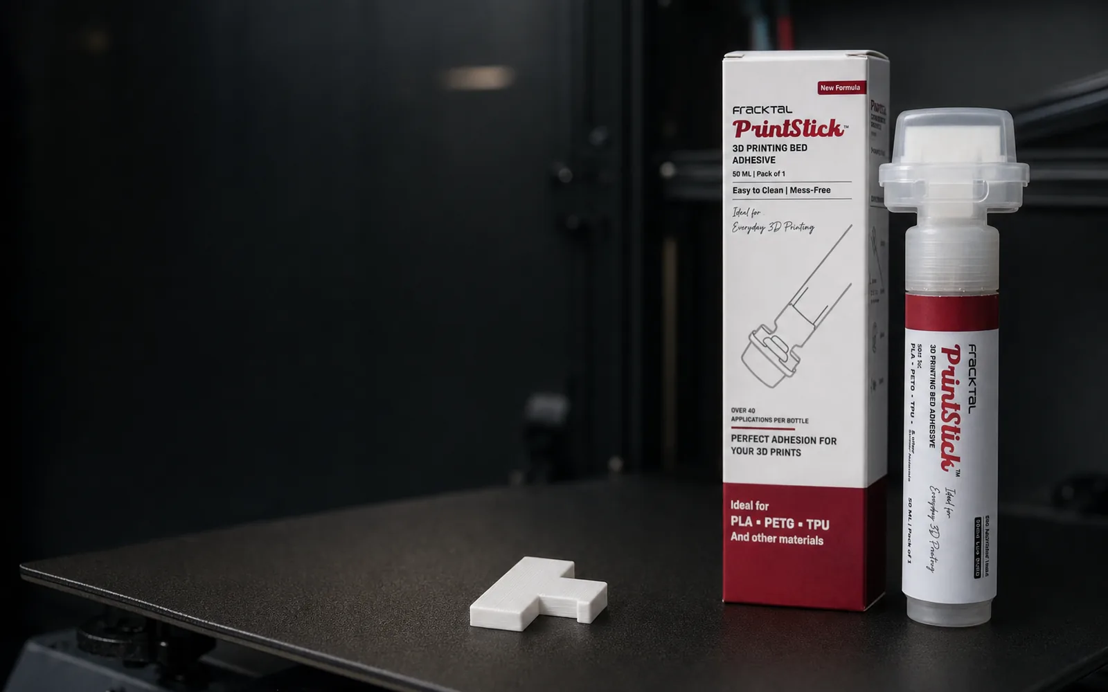 PrintStick 3D printer bed adhesive stick and box beside a build plate holding a flat first layer