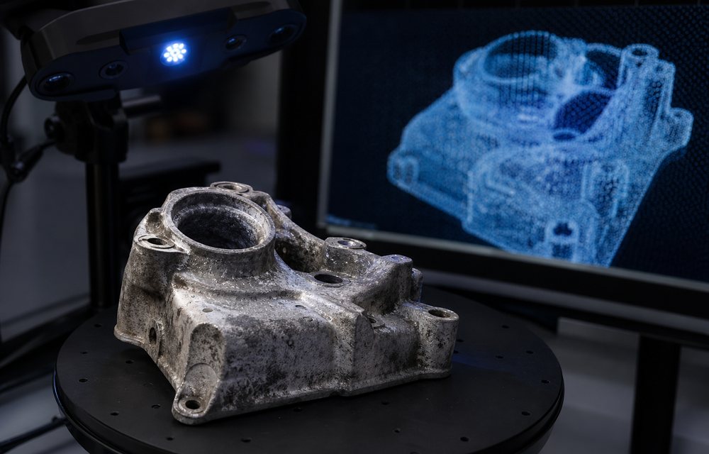 A worn metal part beside its 3D scanned point cloud