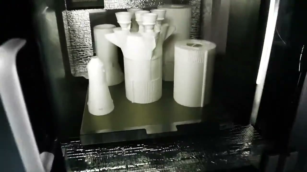 Fracktal Volterra 400 high-temperature industrial 3D printer with printed nylon parts in its heated chamber