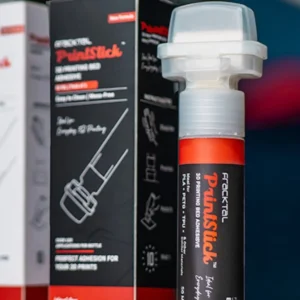 A PrintStick Standard 50 ml bed-adhesive applicator beside its retail box